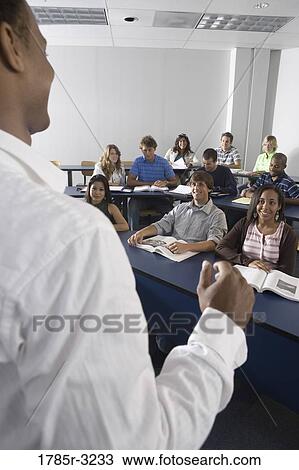 Stock Image - Teacher teaching students in the classroom. Fotosearch