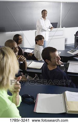 Stock Image - Teacher teaching students in the classroom. Fotosearch