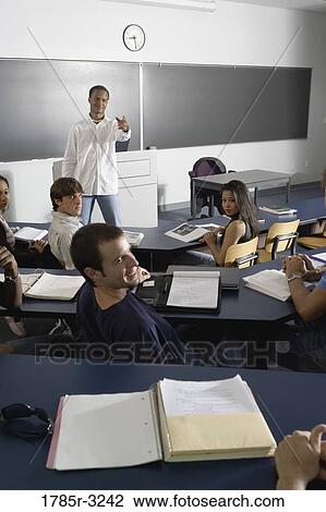 Teacher teaching students in the classroom View Large Photo Image Stock Image - Teacher teaching students in the classroom. Fotosearch