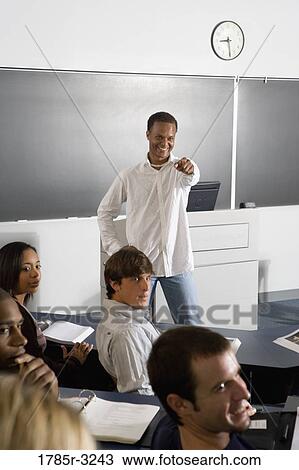 Teacher teaching students in the classroom View Large Photo Image Stock Image - Teacher teaching students in the classroom. Fotosearch