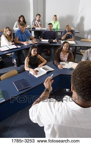 Teacher teaching students in the classroom View Large Photo Image Stock Image - Teacher teaching students in the classroom. Fotosearch