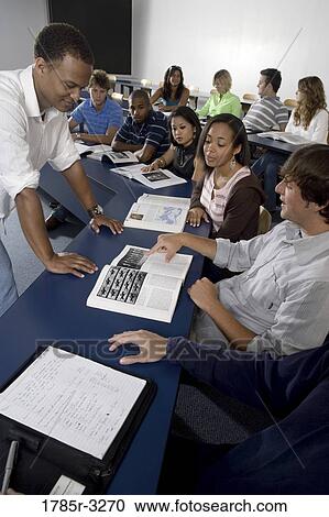 Teacher teaching students in the classroom View Large Photo Image Stock Image - Teacher teaching students in the classroom. Fotosearch