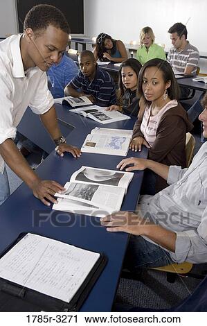 Teacher teaching students in the classroom View Large Photo Image Stock Image - Teacher teaching students in the classroom. Fotosearch