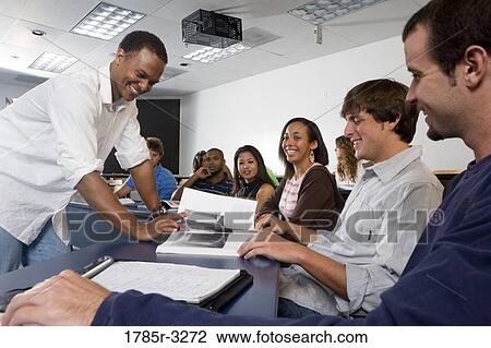 Teacher teaching students in the classroom View Large Photo Image Stock Image - Teacher teaching students in the classroom. Fotosearch