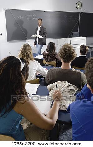 Teacher teaching students in the classroom View Large Photo Image Stock Image - Teacher teaching students in the classroom. Fotosearch