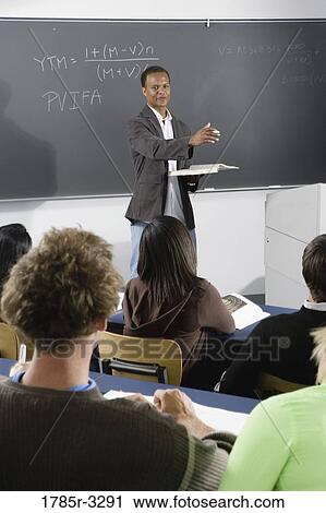 Teacher teaching students in the classroom View Large Photo Image Stock Image - Teacher teaching students in the classroom. Fotosearch