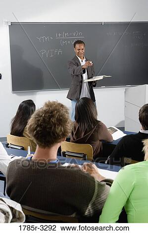 Teacher teaching students in the classroom View Large Photo Image Stock Image - Teacher teaching students in the classroom. Fotosearch