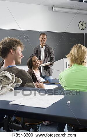 Teacher teaching students in the classroom View Large Photo Image Stock Image - Teacher teaching students in the classroom. Fotosearch