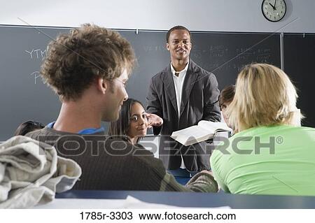 Teacher teaching students in the classroom View Large Photo Image Stock Image - Teacher teaching students in the classroom. Fotosearch
