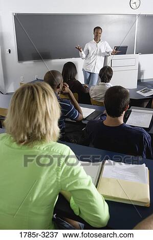 Teacher teaching students in the classroom View Large Photo Image Stock Photo - Teacher teaching students in the classroom. Fotosearch