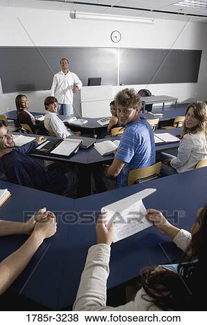 Teacher teaching students in the classroom View Large Photo Image Stock Photo - Teacher teaching students in the classroom. Fotosearch