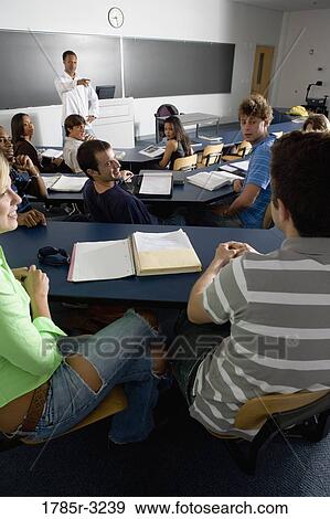 Teacher teaching students in the classroom View Large Photo Image Stock Photo - Teacher teaching students in the classroom. Fotosearch