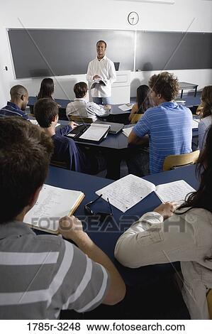 Teacher teaching students in the classroom View Large Photo Image Stock Photo - Teacher teaching students in the classroom. Fotosearch