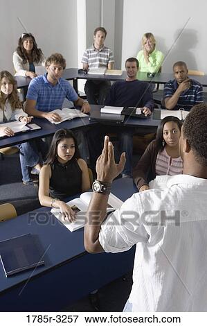 Teacher teaching students in the classroom View Large Photo Image Stock Photo - Teacher teaching students in the classroom. Fotosearch