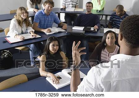 Teacher teaching students in the classroom View Large Photo Image Stock Photo - Teacher teaching students in the classroom. Fotosearch