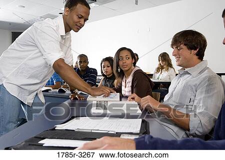 Teacher teaching students in the classroom View Large Photo Image Stock Photo - Teacher teaching students in the classroom. Fotosearch
