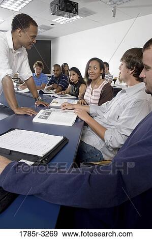 Teacher teaching students in the classroom View Large Photo Image Stock Photo - Teacher teaching students in the classroom. Fotosearch