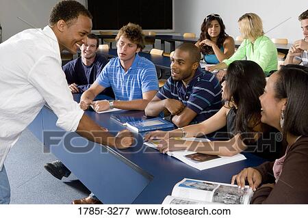 Teacher teaching students in the classroom View Large Photo Image Stock Photo - Teacher teaching students in the classroom. Fotosearch