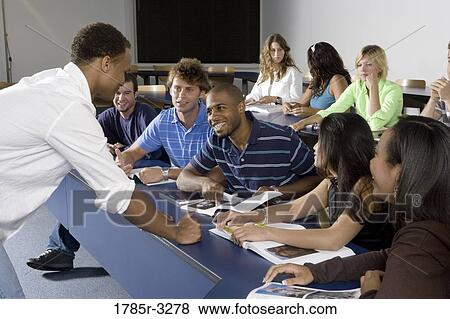 Teacher teaching students in the classroom View Large Photo Image Stock Photo - Teacher teaching students in the classroom. Fotosearch