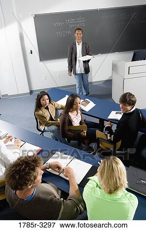 Teacher teaching students in the classroom View Large Photo Image Stock Photo - Teacher teaching students in the classroom. Fotosearch