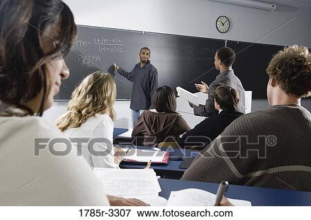 Stock Photo - Teacher teaching students in the classroom. Fotosearch