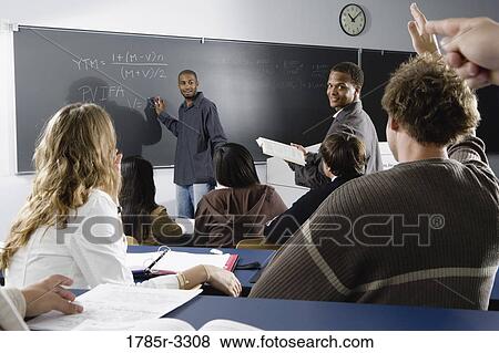 Teacher teaching students in the classroom View Large Photo Image Stock Photo - Teacher teaching students in the classroom. Fotosearch
