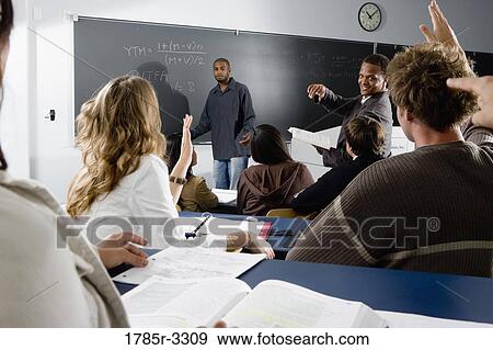 Teacher teaching students in the classroom View Large Photo Image Stock Photo - Teacher teaching students in the classroom. Fotosearch
