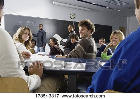 Teacher teaching students in the classroom View Large Photo Image Stock Photo - Teacher teaching students in the classroom. Fotosearch