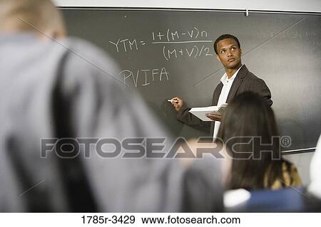 Teacher teaching students in the classroom View Large Photo Image Stock Photo - Teacher teaching students in the classroom. Fotosearch