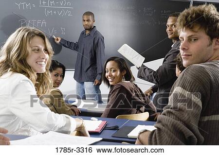 Stock Photograph - Teacher teaching students in the classroom. Fotosearch