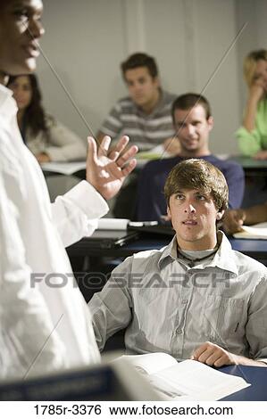 Stock Photograph - Teacher teaching students in the classroom. Fotosearch