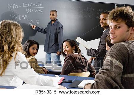 Teacher teaching students in the classroom View Large Photo Image Stock Photography - Teacher teaching students in the classroom. Fotosearch