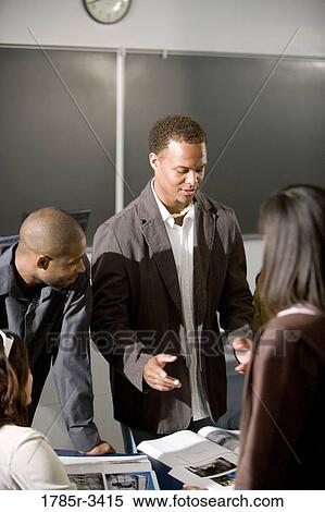 Teacher teaching students in the classroom View Large Photo Image Stock Photography - Teacher teaching students in the classroom. Fotosearch