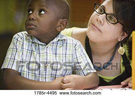 Teacher with student looking up View Large Photo Image Stock Photography - Teacher with student looking up. Fotosearch