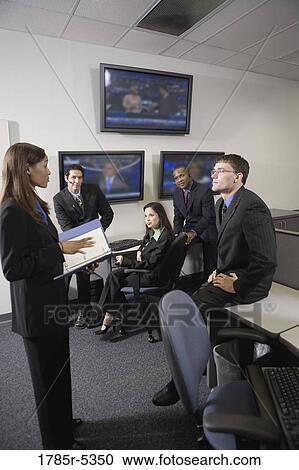Stock Image - Team meeting in an office. Fotosearch