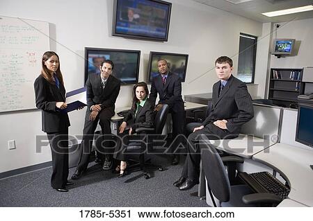 Stock Image - Team meeting in an office. Fotosearch