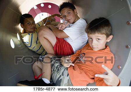 Three boys posing together on the playground View Large Photo Image Stock Photo - Three boys posing together on the playground. Fotosearch