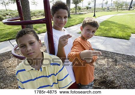 Three boys posing together on the playground View Large Photo Image Stock Photography - Three boys posing together on the playground. Fotosearch