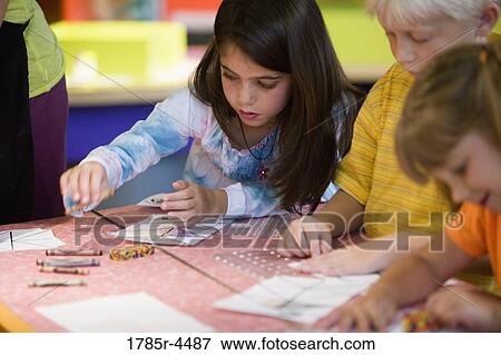 Three children coloring with crayons View Large Photo Image Stock Photo - Three children coloring with crayons. Fotosearch