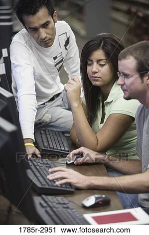 Three university students using computer View Large Photo Image Stock Image - Three university students using computer. Fotosearch