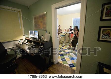 Three women having drinks in kitchen next to home office View Large Photo Image Stock Image - Three women having drinks in kitchen next to home office. Fotosearch