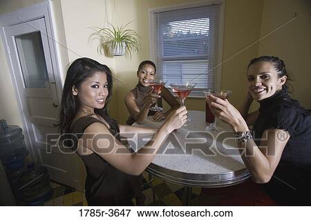 Three women having drinks in kitchen View Large Photo Image Stock Photo - Three women having drinks in kitchen. Fotosearch