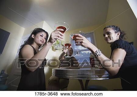 Three women having drinks in kitchen View Large Photo Image Stock Photo - Three women having drinks in kitchen. Fotosearch