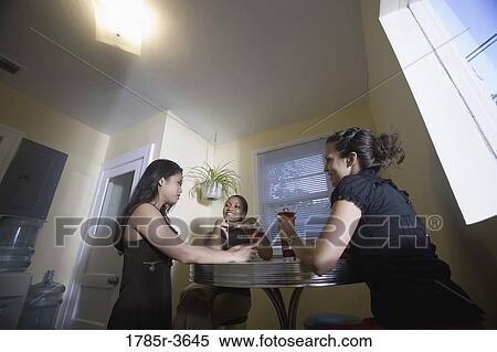 Three women having drinks in kitchen View Large Photo Image Stock Photography - Three women having drinks in kitchen. Fotosearch