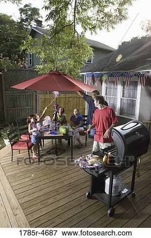 Two families on backyard patio celebrating 4th of July View Large Photo Image Stock Photo - Two families on backyard patio celebrating 4th of July. Fotosearch