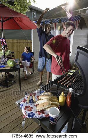 Two families on backyard patio celebrating 4th of July View Large Photo Image Stock Photography - Two families on backyard patio celebrating 4th of July. Fotosearch