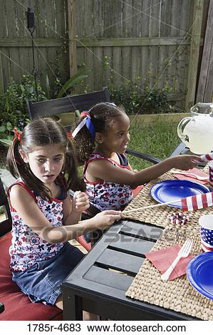 Two girls celebrating the 4th of July in their backyard View Large Photo Image Stock Image - Two girls celebrating the 4th of July in their backyard. Fotosearch