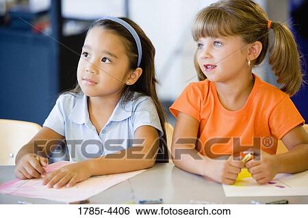 Two little girls coloring together View Large Photo Image Stock Photograph - Two little girls coloring together. Fotosearch