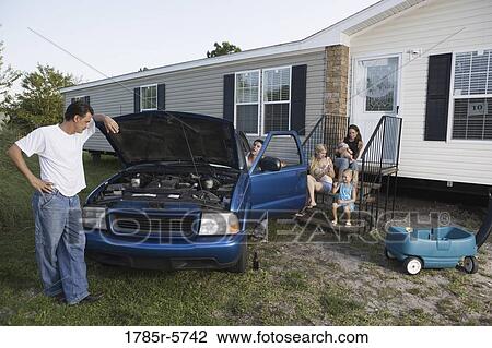 Two men attempting to repair a pickup truck in front of trailer home View Large Photo Image Stock Image - Two men attempting to repair a pickup truck in front of trailer home. Fotosearch