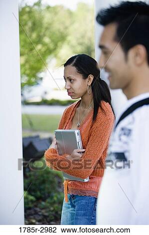 Two students standing View Large Photo Image Stock Image - Two students standing. Fotosearch